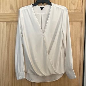 Scalloped wrap blouse. Drop back.